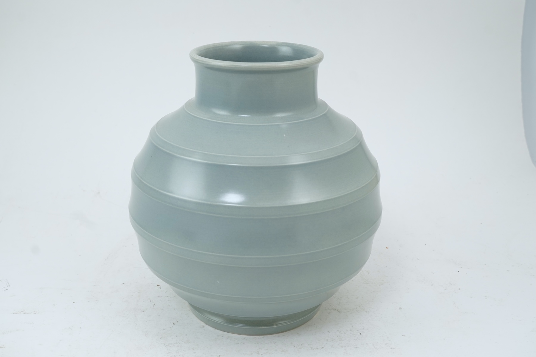 Keith Murray MC RDI FRIBA (New Zealand/British, 1892-1981) for Wedgwood: A pale blue glazed globe or 'bomb' vase